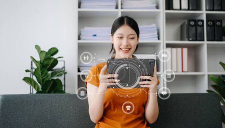 Photo for Woman using tablet pc for mobile payments online shopping,omni channel,sitting on table,virtual icons graphics interface screen in morning light - Royalty Free Image