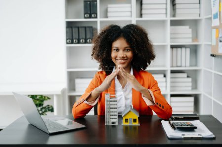 Photo for African Female real estate agent . real estate investment about house trading, purchase at desk in office - Royalty Free Image