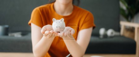 Photo for Asian woman and piggy bank  for business, finance, saving money and property investment concept - Royalty Free Image