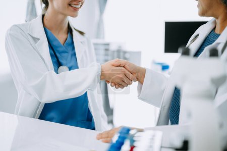 Photo for Doctor handshake and partnership in healthcare, medicine or trust for collaboration, unity or support.Team of medical experts shaking hands in teamwork for or success in clinic or hospital - Royalty Free Image
