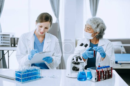 Photo for Scientist team meeting and writing analysis results in the laboratory study and analyze scientific sampl - Royalty Free Image