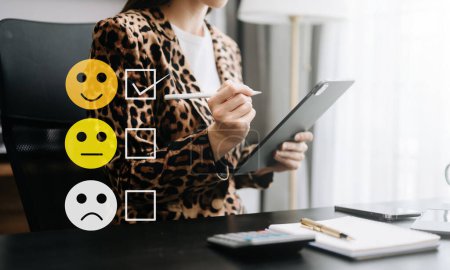 Photo for Cropped image of business woman wearing leopard jacket, sitting at office table and using digital tablet, face icons - Royalty Free Image