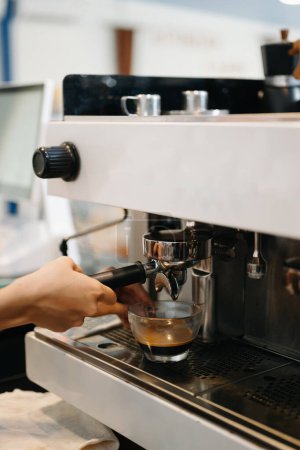 Foto de Máquina de café espresso profesional vertiendo café fresco en una taza de vidrio - Imagen libre de derechos
