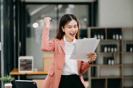Photo for Confident Asian woman with a smile standing in modern office - Royalty Free Image