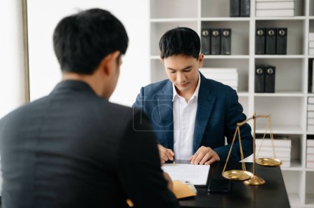 Photo for Asian business team and lawyers discussing contract papers sitting at the table. Concepts of law, advice, legal services. at modern office - Royalty Free Image