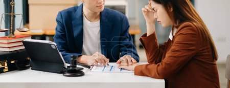 Photo for Business people compassionately holding hands and discussing contract  in the office - Royalty Free Image