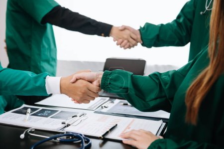 Photo for Doctors handshake and partnership in healthcare, medicine or trust for collaboration, unity or support.Team of medical experts shaking hands in teamwork for or success in hospital - Royalty Free Image