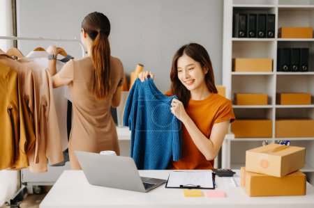 Téléchargez les photos : Concept de blogueur de mode, Jeune femme asiatique vendant des vêtements en ligne. Création de petites entreprises PME - en image libre de droit
