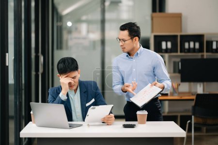 Photo for Angry two Asian businessmen arguing after making a mistake at work - Royalty Free Image