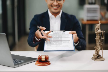 Photo for Justice and law concept. Happy Asian male lawyer working with laptop and documents in office - Royalty Free Image