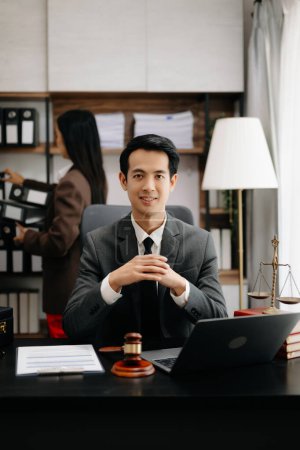 Photo for Asian lawyer man working with a laptop in a law office. Legal and legal service concept - Royalty Free Image
