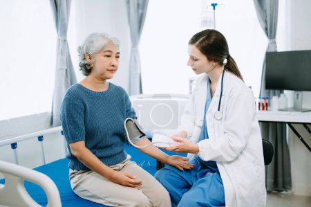 Photo for Doctor and patient discussing something while on examination bed in modern clinic or hospital. Medicine and health care concept - Royalty Free Image