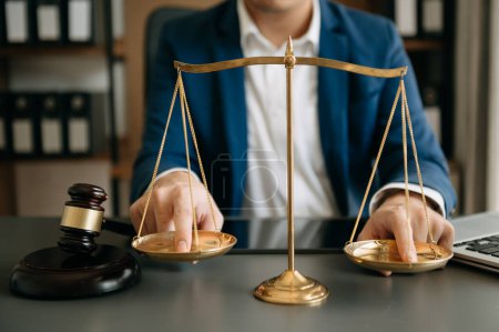 Photo for Male lawyer in the office with brass scale on wooden table. justice and law concept in morning ligh - Royalty Free Image