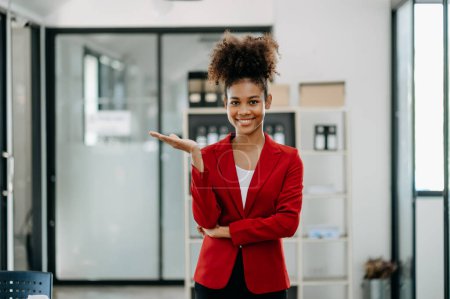 Photo for Smiling african woman standing at modern office - Royalty Free Image