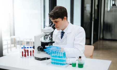 Photo for Modern medical research laboratory. Male scientist working with micro pipettes, and analyzing biochemical samples - Royalty Free Image
