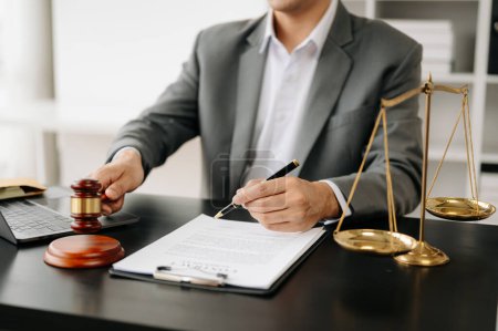 Foto de Concepto de justicia y derecho. Juez masculino en un tribunal sobre mesa negra. Abogado masculino trabajando en oficina - Imagen libre de derechos