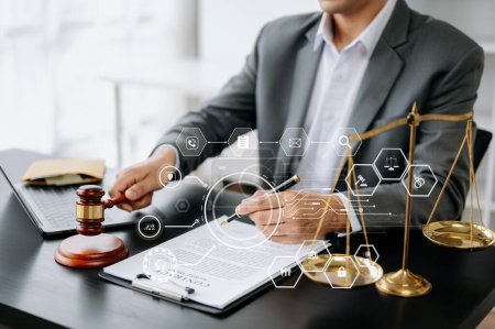 Photo for Justice and law concept. Male judge in a courtroom  the gavel, working with digital tablet computer on wooden table - Royalty Free Image