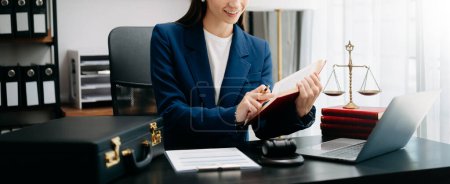 Photo for Justice and law concept. Judge in a courtroom at wooden table working in office. - Royalty Free Image