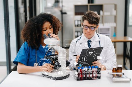 Photo for Doctor Talks With Professional Head Nurse or Surgeon, They Use microscope. Diverse Team of Health Care Specialists Discussing Test Result on desk in hospital - Royalty Free Image