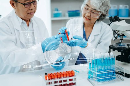 Photo for Scientist two Asian senior working in laboratory and ecofriendly science. Scientists analyzing test samples for global warming and tech with virtual icon screen - Royalty Free Image