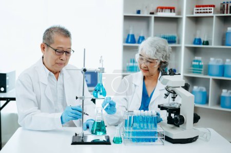 Photo for Two Asian senior Scientist team meeting and analyzing results in the laboratory - Royalty Free Image
