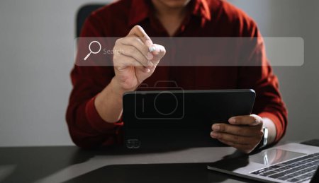 Photo for Searching Browsing Internet Data Information Networking Concept with blank search bar. man working with digital tabllet and laptop computer in office - Royalty Free Image