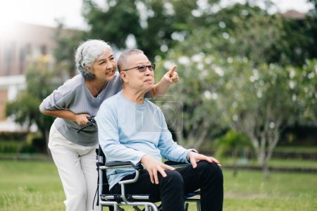 Photo for Asian senior couple having a good time. They laughing and smiling outdoor in the park. Lovely senior couple - Royalty Free Image
