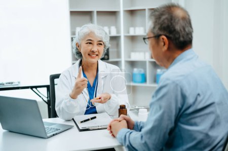 Photo for Asian Senior Doctor and patient discussing something while sitting at the table . Medicine and health care concept - Royalty Free Image