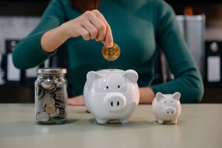 Photo for Women are putting coins in a piggy bank for a business that grows for profit and saving money for the future. planning for retirement concep - Royalty Free Image
