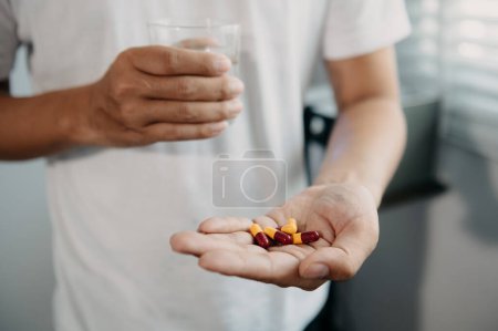 Photo for Pills in hands. Painful yound age. Caring for the health of the elderly - Royalty Free Image