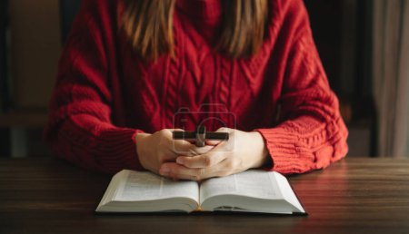 Photo for Woman praying on holy bible in the morning.Woman hand swith Bible praying. Christian life crisis prayer to god in sun light - Royalty Free Image