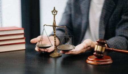 Photo for Male lawyer in the modern office with brass scale on wooden table. justice and law concept in morning light - Royalty Free Image