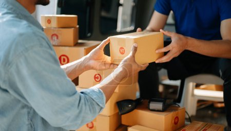 Photo for Parcel delivery with good depth of field. Friendly worker giving a box to client. Shipping concept - Royalty Free Image
