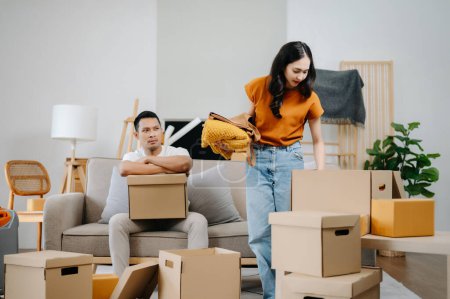 Photo for Young couple with big boxes moving into a new house, new apartment for couple - Royalty Free Image