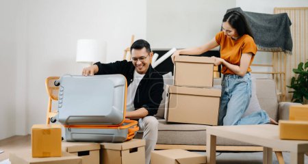 Photo for Young couple with big boxes moving into a new house, new apartment for couple - Royalty Free Image