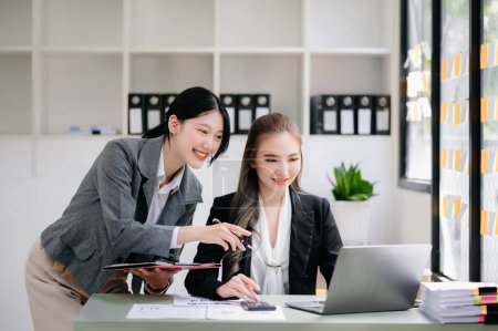 Photo for Businesswomen work and discuss their business plans in modern office - Royalty Free Image