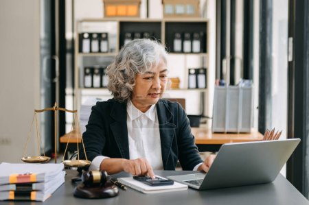 Photo for Senior asian woman lawyer working in the office. Advice justice and law concept - Royalty Free Image