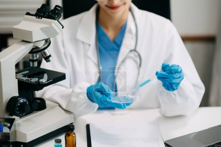 Photo for Modern medical research laboratory. female scientist working with micro pipettes analyzing biochemical samples, advanced science chemical laboratory for medicine. - Royalty Free Image