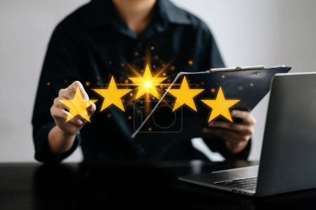 Photo for Businessman working on laptop. Customer or client the stars to complete five stars. with copy space. giving a five star rating. Service rating, satisfaction concept - Royalty Free Image
