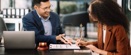 Photo for Asian business team of lawyers discussing contract papers sitting at the table. Concepts of law, advice, legal services in office - Royalty Free Image