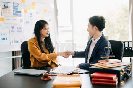 Photo for Asian business people and lawyers discussing contract papers sitting at the table. Concepts of law, advice, legal services. in morning light - Royalty Free Image