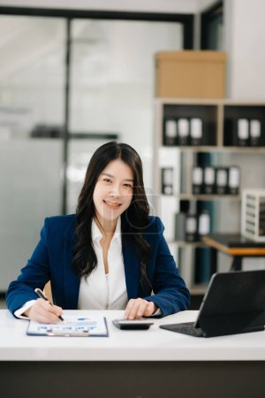 Photo for Confident business expert attractive smiling young woman using laptop computer on desk in creative office - Royalty Free Image