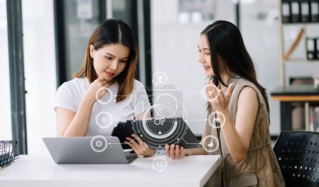 Photo for Working team meeting concept, Asian business using laptop and digital tablet computer with digital marketing media  in virtual icon network diagram office in morning light - Royalty Free Image