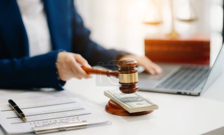 Photo for Justice and law concept. law theme wooden desk, books, balance. judge in a courtroom the gavel, working with laptop on table - Royalty Free Image