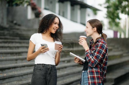 Photo for Young female college students drinking coffee in campus - Royalty Free Image