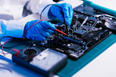 Photo for The technician is putting the CPU on the socket of the computer motherboard. electronic engineering electronic repair, electronics measuring and testing, repair in workshop - Royalty Free Image