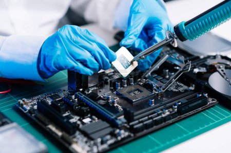 Photo for The technician repairing the motherboard in the lab with copy space. the concept of computer hardware, electronic, repairing, upgrade blue effect - Royalty Free Image