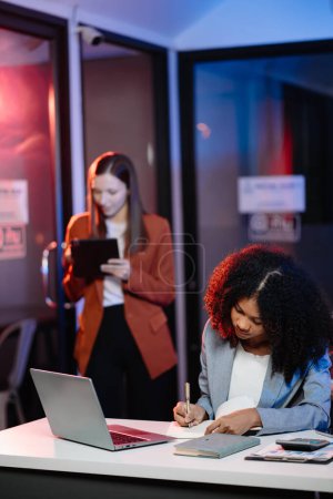 Photo for Businesswomen working together on a project with computer at modern office - Royalty Free Image