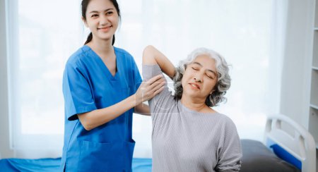 Photo for Female Doctor and patient suffering from back pain during medical exam. on the bed in clini - Royalty Free Image