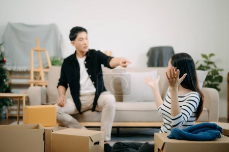 Photo for Divorce. Asian couples are desperate and disappointed after marriage. Husband and wife are sad, upset and frustrated after quarrels. family problem, teenage love. on sofa at home - Royalty Free Image